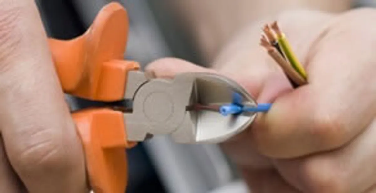 professional electrical services showing precise wire cutting by licensed electricians in Chandler, AZ